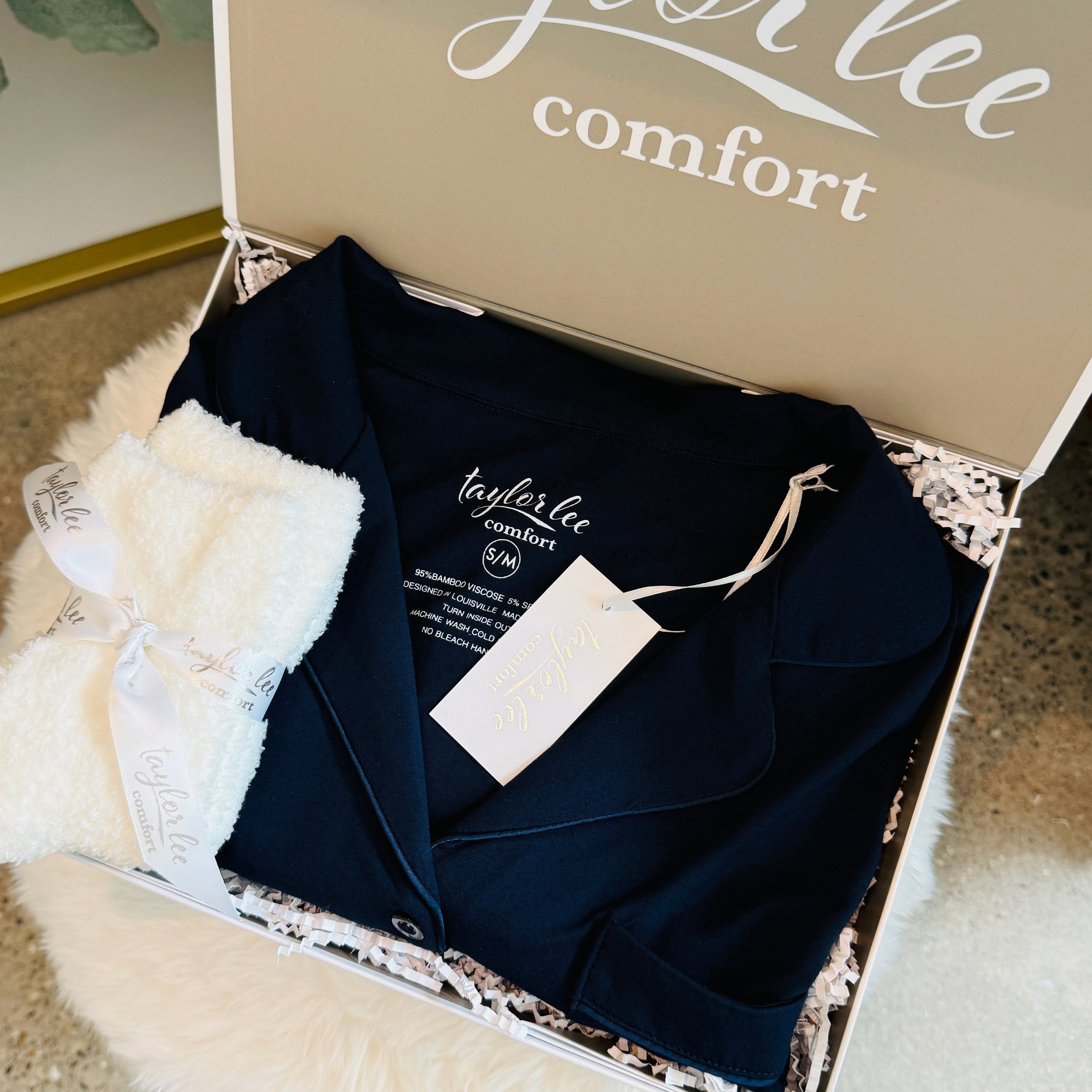 deep navy blue button down sleep shirt and ivory plush socks tied with satin ribbon all presented in a beautiful Taylor Lee Comfort gift box