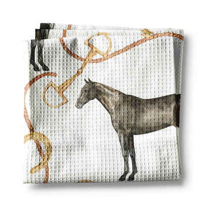 Folded fabric with horse and bridle pattern on a white background