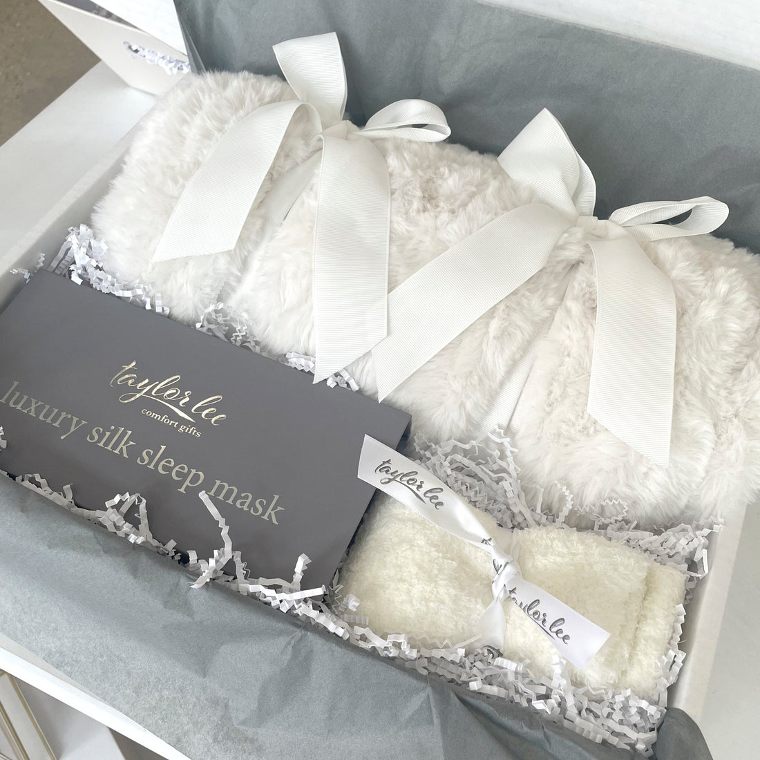 Plush Ivory blanket and soft cozy socks in beautiful gift box. 