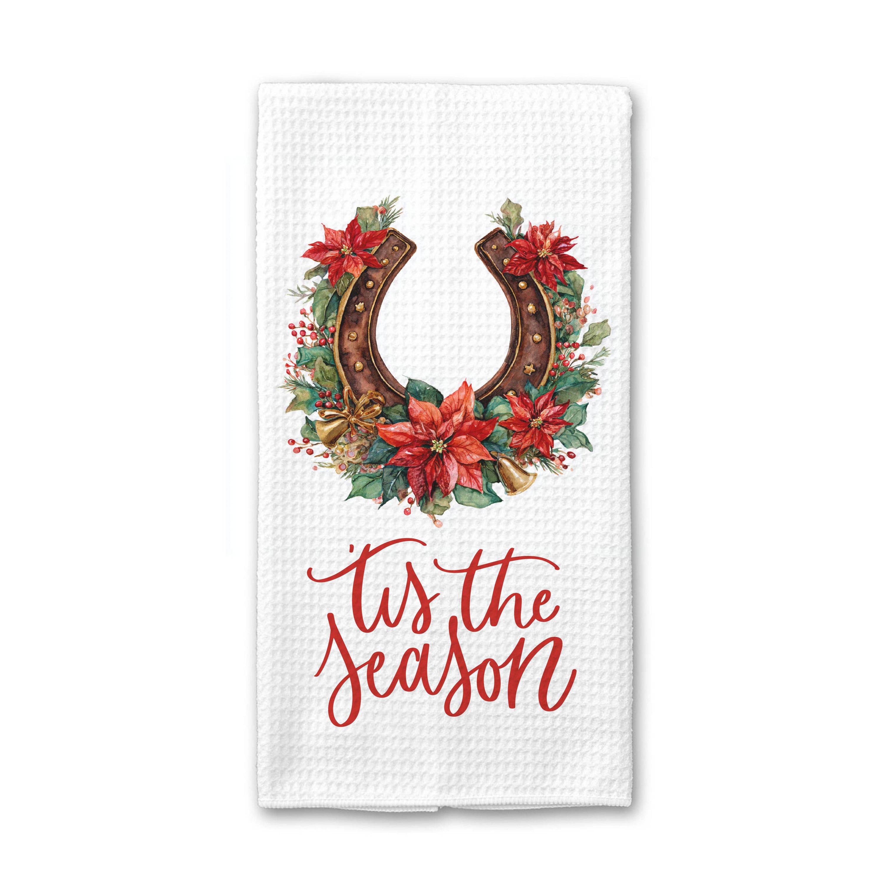 A white waffle-weave kitchen towel featuring a festive graphic with a brown horseshoe wreath decorated with red poinsettias and green leaves, above the red cursive text &