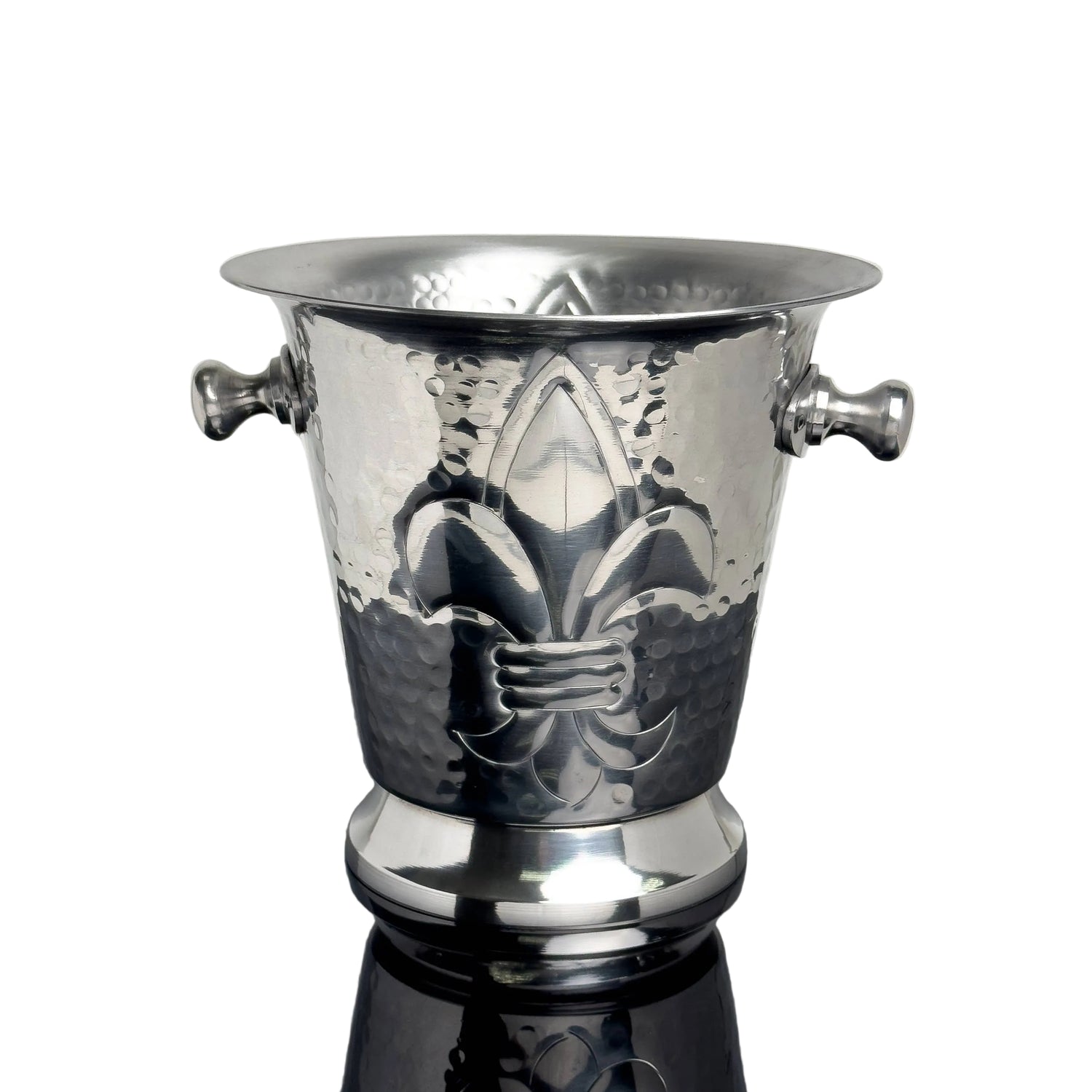 Silver wine cooler with fleur-de-lis design on a reflective surface