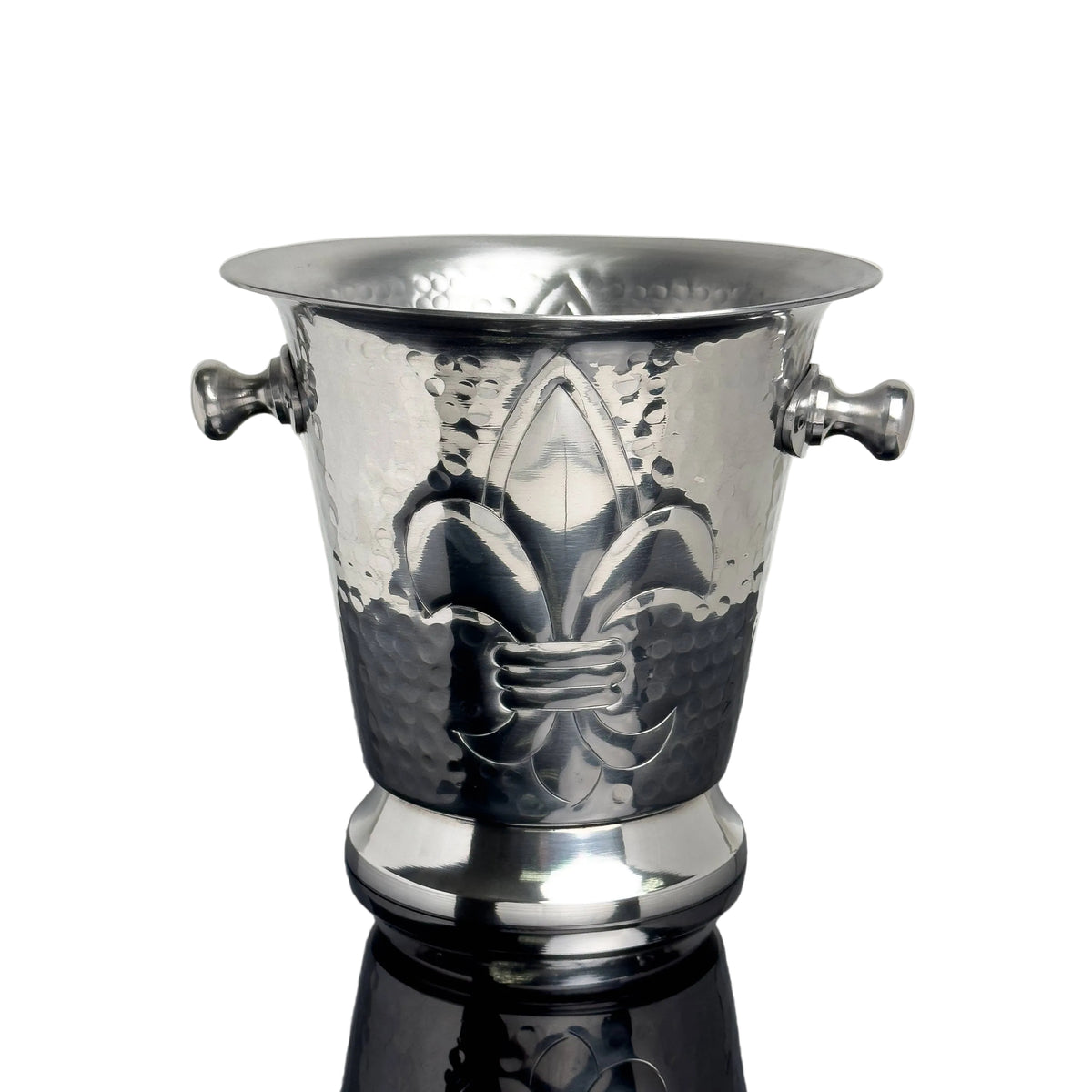 Silver wine cooler with fleur-de-lis design on a reflective surface