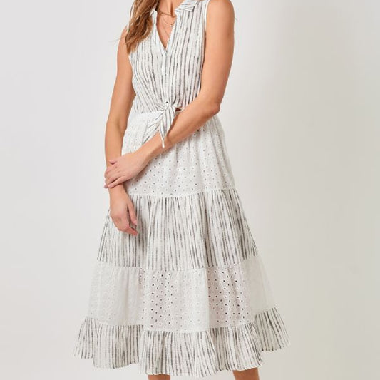 Woman wearing classic and comfortable white dress with black patterns on a white background